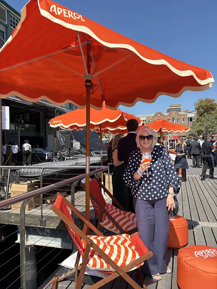 Colleen at the Wharf4Ward under orange umbrellas